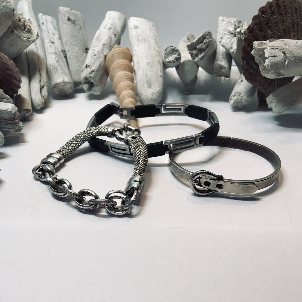 THREE SILVER BRACELETS. ONE HAS LEATHER PEICES.